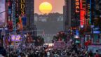 The Sun sets in alignment with Manhattan streets running east-west, also known as Manhattanhenge, in New York City on May 30, 2023